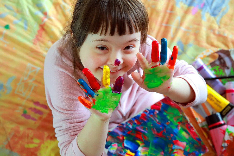 Child with special needs participating in a colourful activity