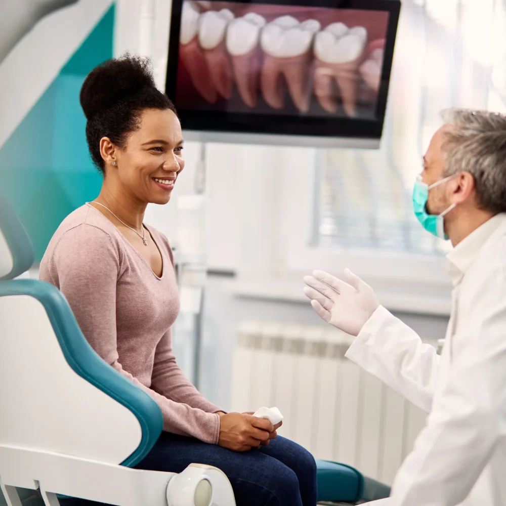 happy-black-woman-talking-to-her-orthodontist-at-d-2024-12-13-18-19-47-utc